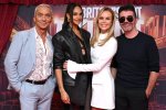 a group of people standing in front of a sign that says britain 's got talent