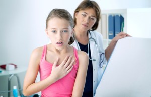 a young girl is being examined by a doctor