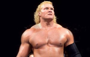 a wrestler with blonde hair and a black arm band