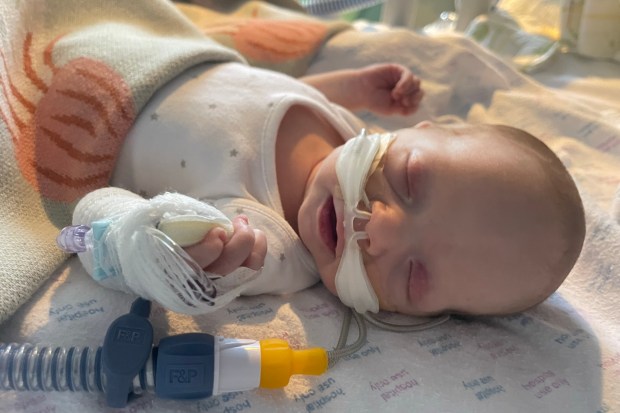 a baby is laying on a blanket that says hospital use only